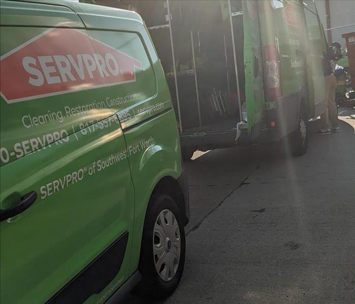 Sun shining over 2 SERVPRO vans.