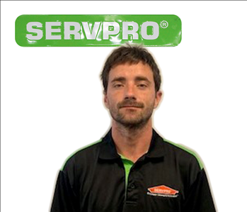 employee with SERVPRO shirt; green sign